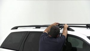 drive more efficiently, man removing roof rack drive more efficiently, man removing roof rack